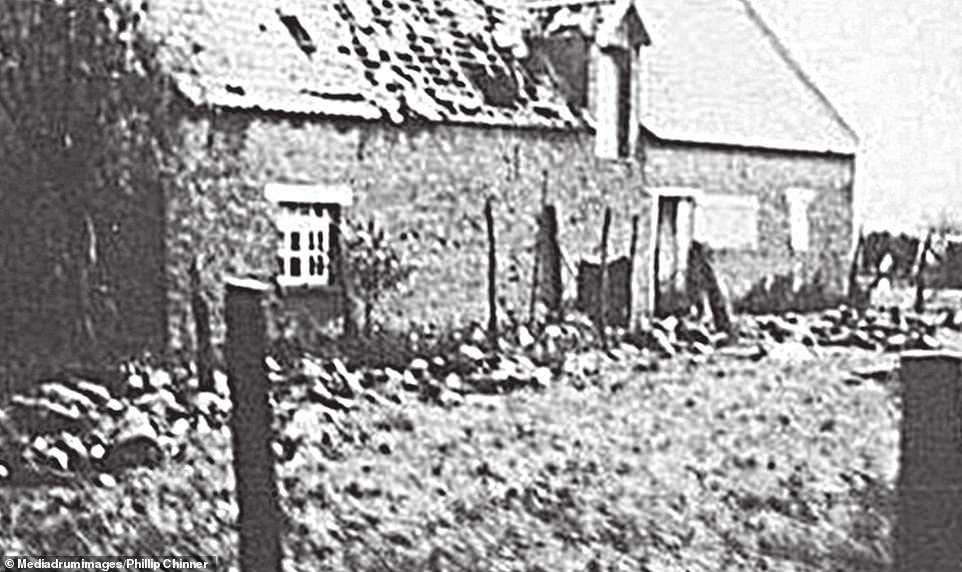 A photo of the bodies of the murdered soldiers of the Royal Norfolk Regiment, still lying next to the barn where they had been shot, taken by a passing German photographer. They were murdered in an incident which became known as the 