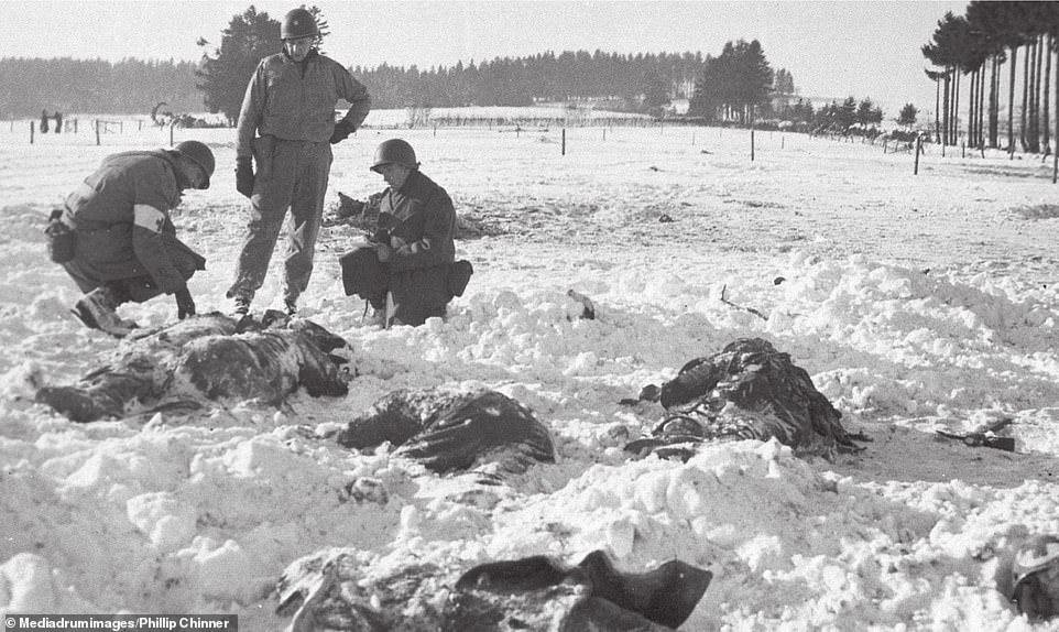 American investigators begin the long process of identifying the men murdered by Nazis during the Battle of the Bulge, 1944. The bodies were taken to the nearby railway station where they were thawed out and identified. The fierce battle took place during a bitterly cold winter in western Europe