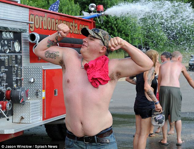 Physical feats: A local Augusta, Georgia fire truck stood by to rinse festival goers of accumulated mud and for posing in front of